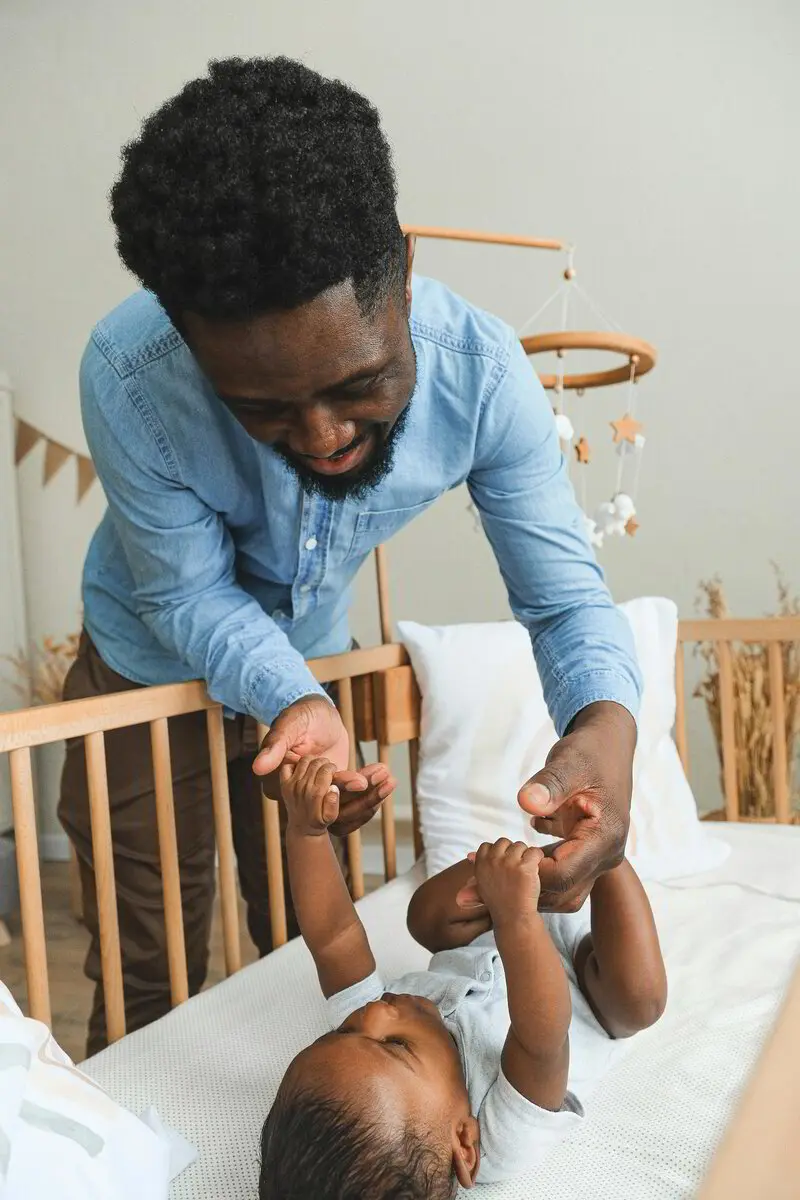 Dad playing with his baby during a diaper change
